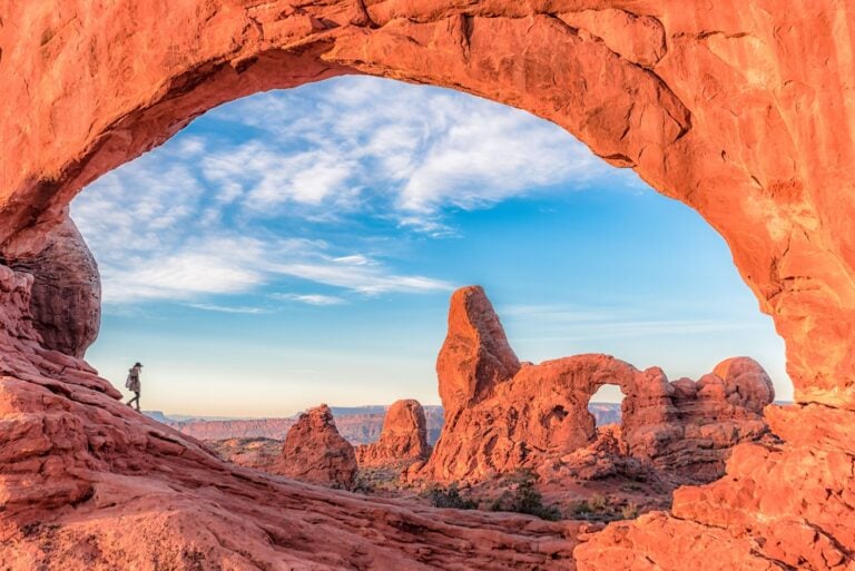 Hiker walking through Arches National Park in Utah