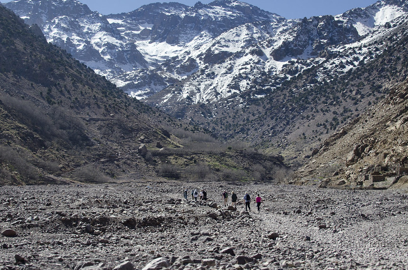 Hikers walking in a line through the Atlas mountains