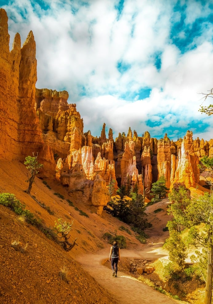 Hiker walking among the hoodoo pillars of Bryce Canyon