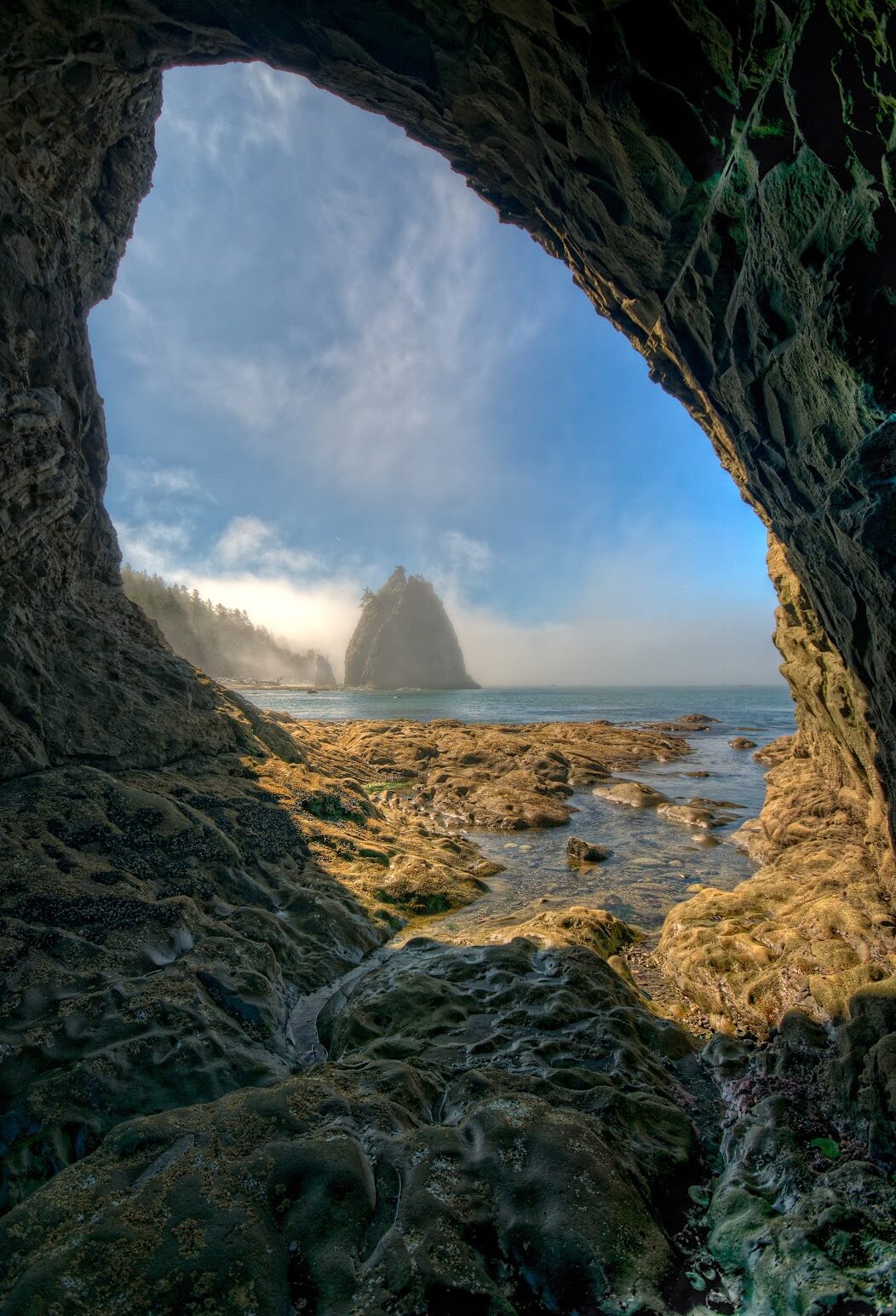 A beautiful view of Rialto Beach of the Olympic Peninsula in Washington State through 'hole in the wall' formation