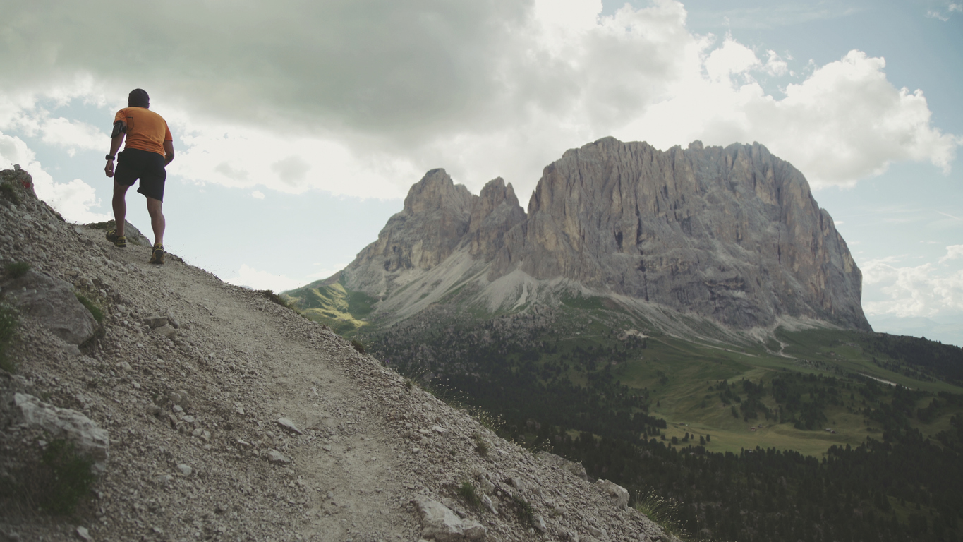 A man trail running in the Dolomites