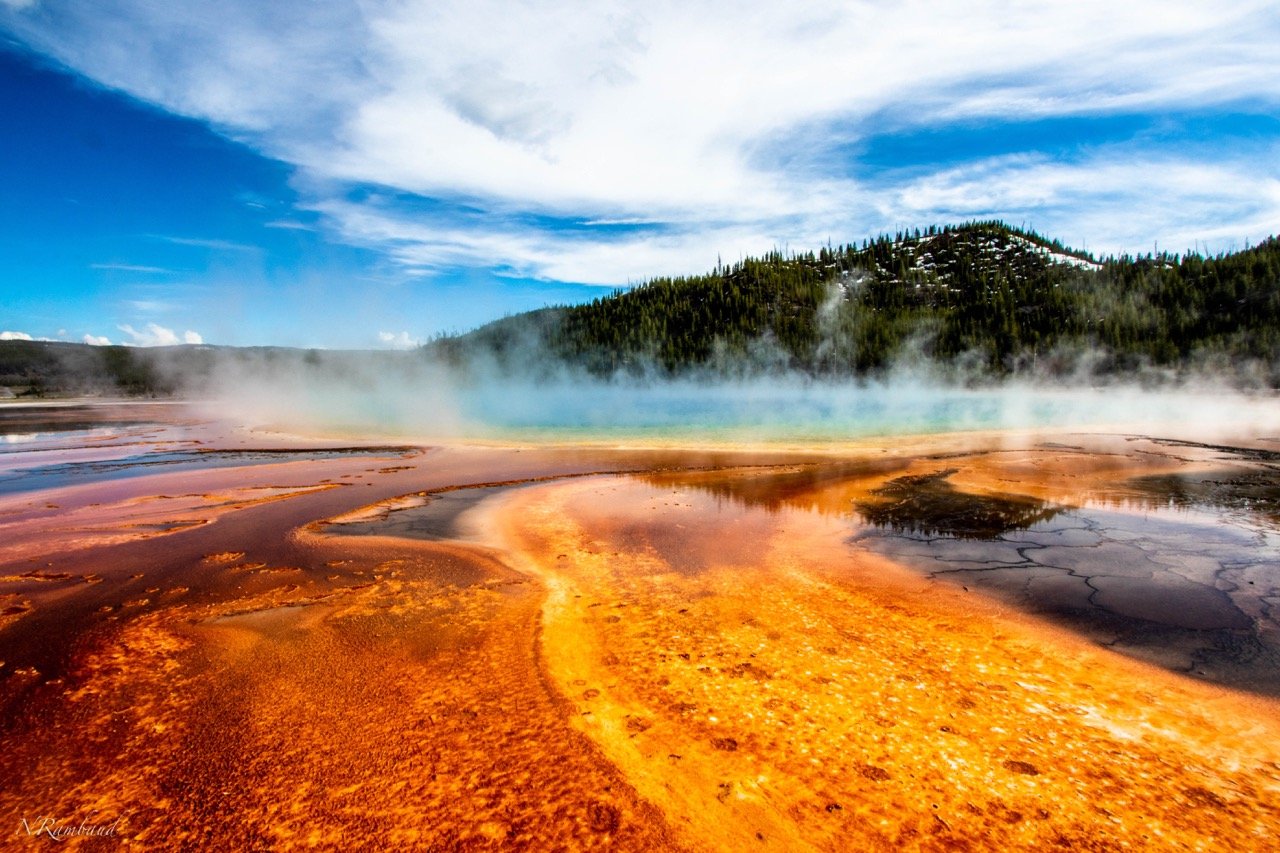 Colorful steamy geyser