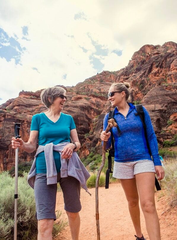 two happy women hiking in utah
