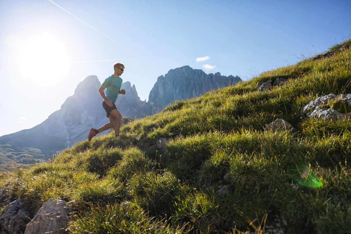 A young man trail running in the Dolomites