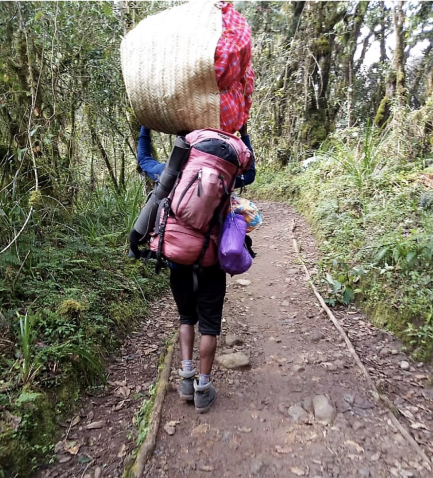 Porters on Kilimanjaro carry a significant load up the mountain, often much heavier than is allowed.