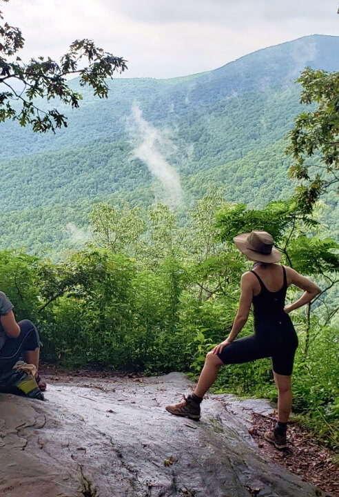 Hikers resting on the rock with an amazing vista over the Appalachian Trail.