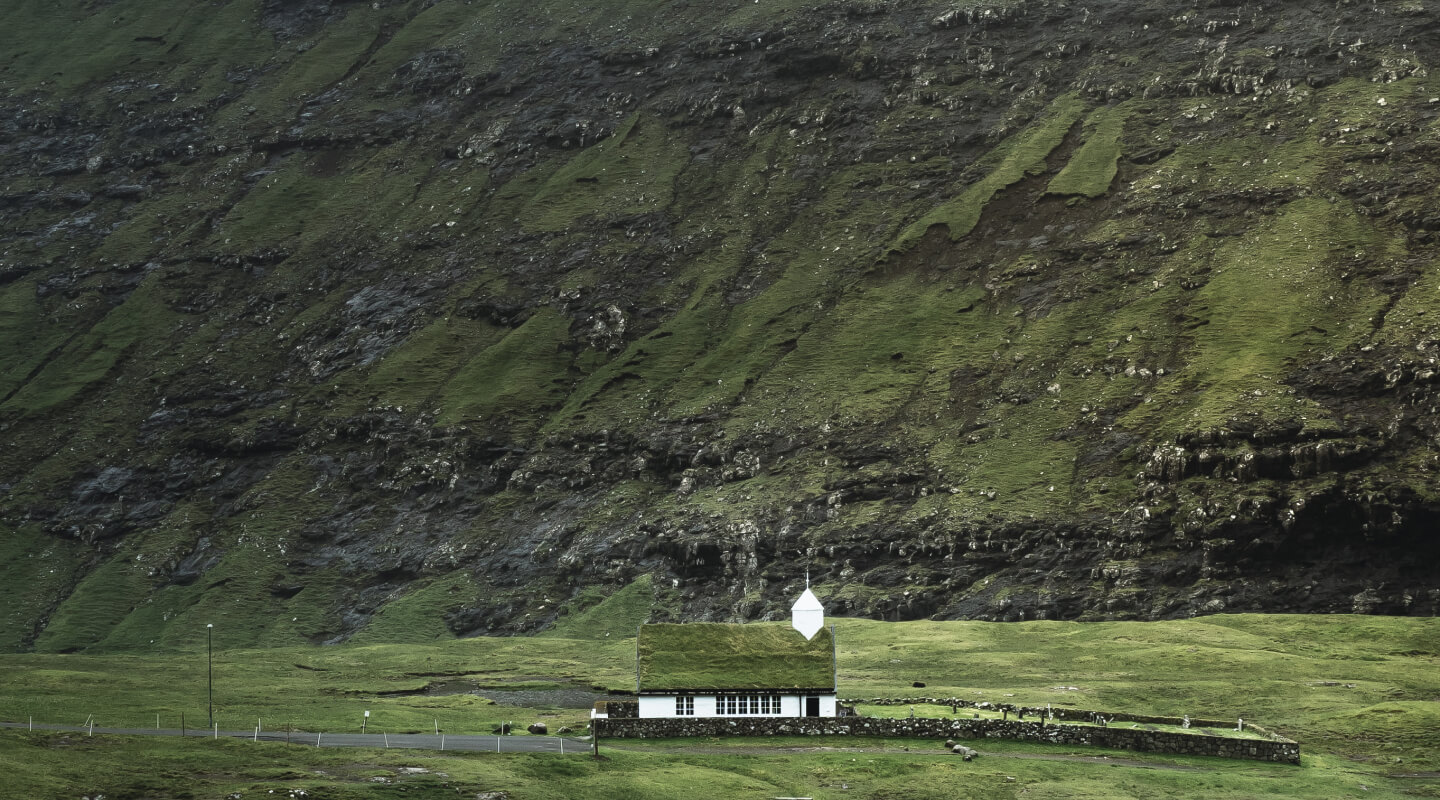 A lonely church amidst the classic breathtaking landscape of the Faroe Islands.