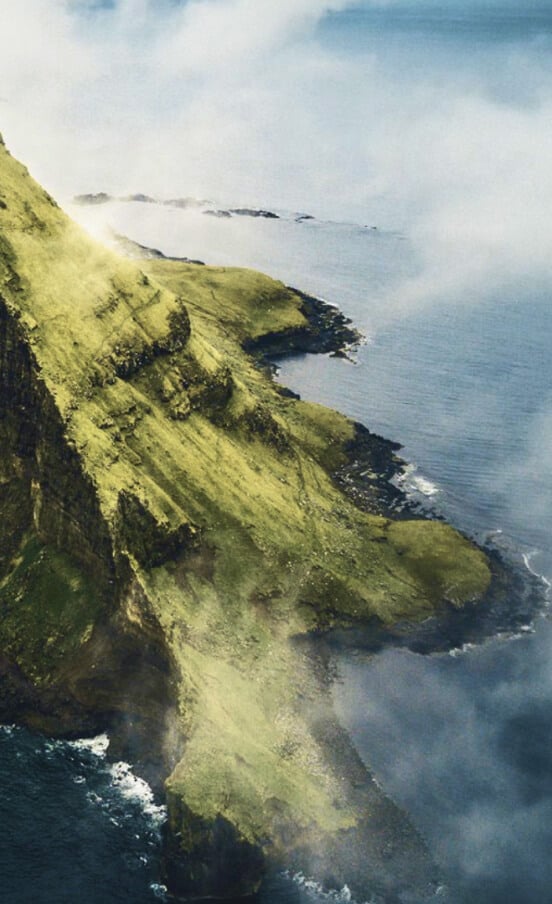 The green coastline of the Faroe Islands invites you to delve deeper into your adventure spirit.