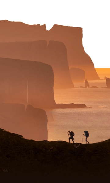 People hiking on the amazing landscape of the Faroe Islands.