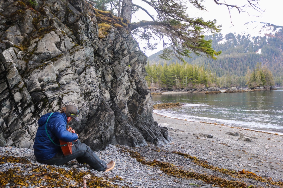 A guide playing the guitar in Prince William Sound