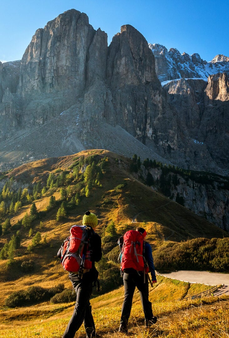 Travelers hiking in breathtaking landscape of Dolomites mountains in summer in Italy.