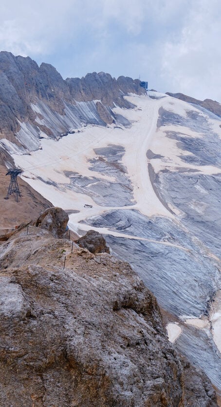 Marmolada glacier in the Italian Dolomites and Rifugio Serauta as seen from the via ferrata route called Eterna (Brigata di Cadore), in summer.