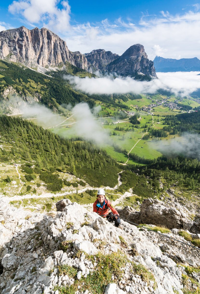 Young female mountain climber on a difficult Via Ferrata in the Dolomites, Alta Badia region.