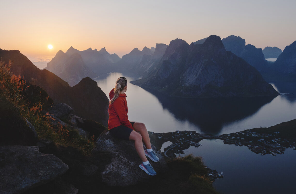 A woman at a mountain top in Lofoten