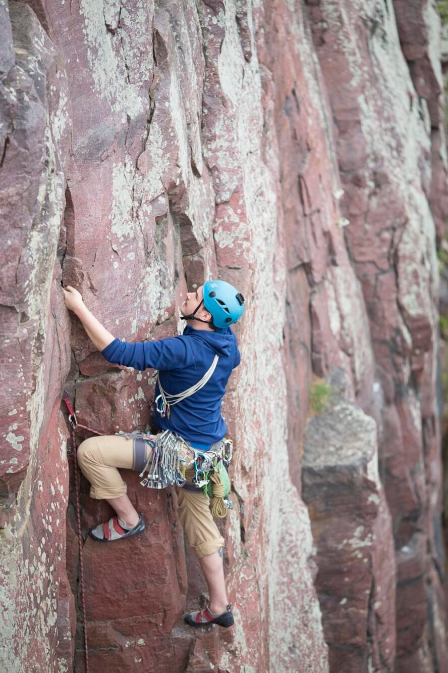 Climber leads on a crack climb in the section of Balanced Rock Wall.