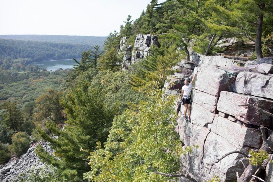 Climber looks over Devil’s Lake State park. 