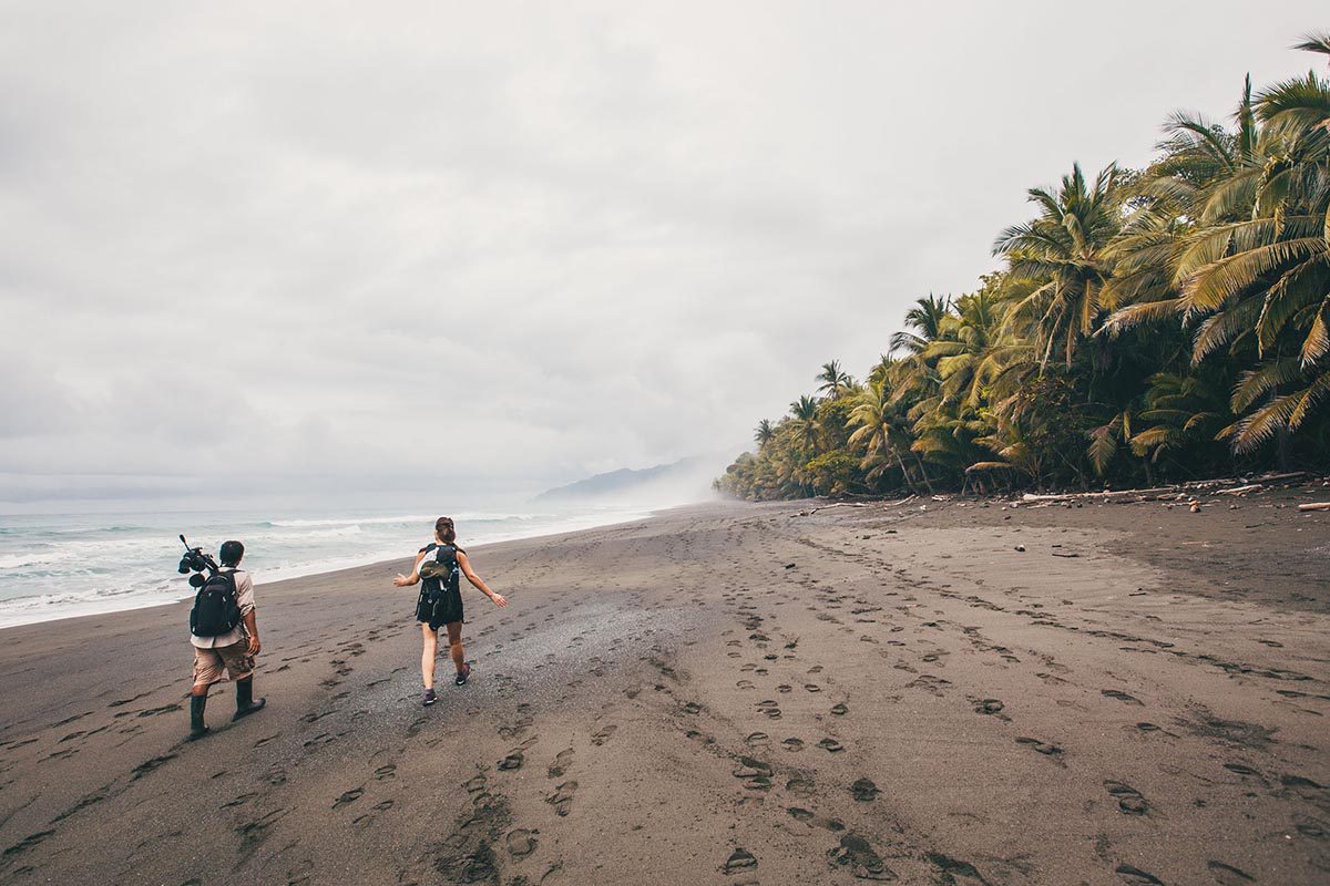 Hikers walking along a beach in Corcovado NP