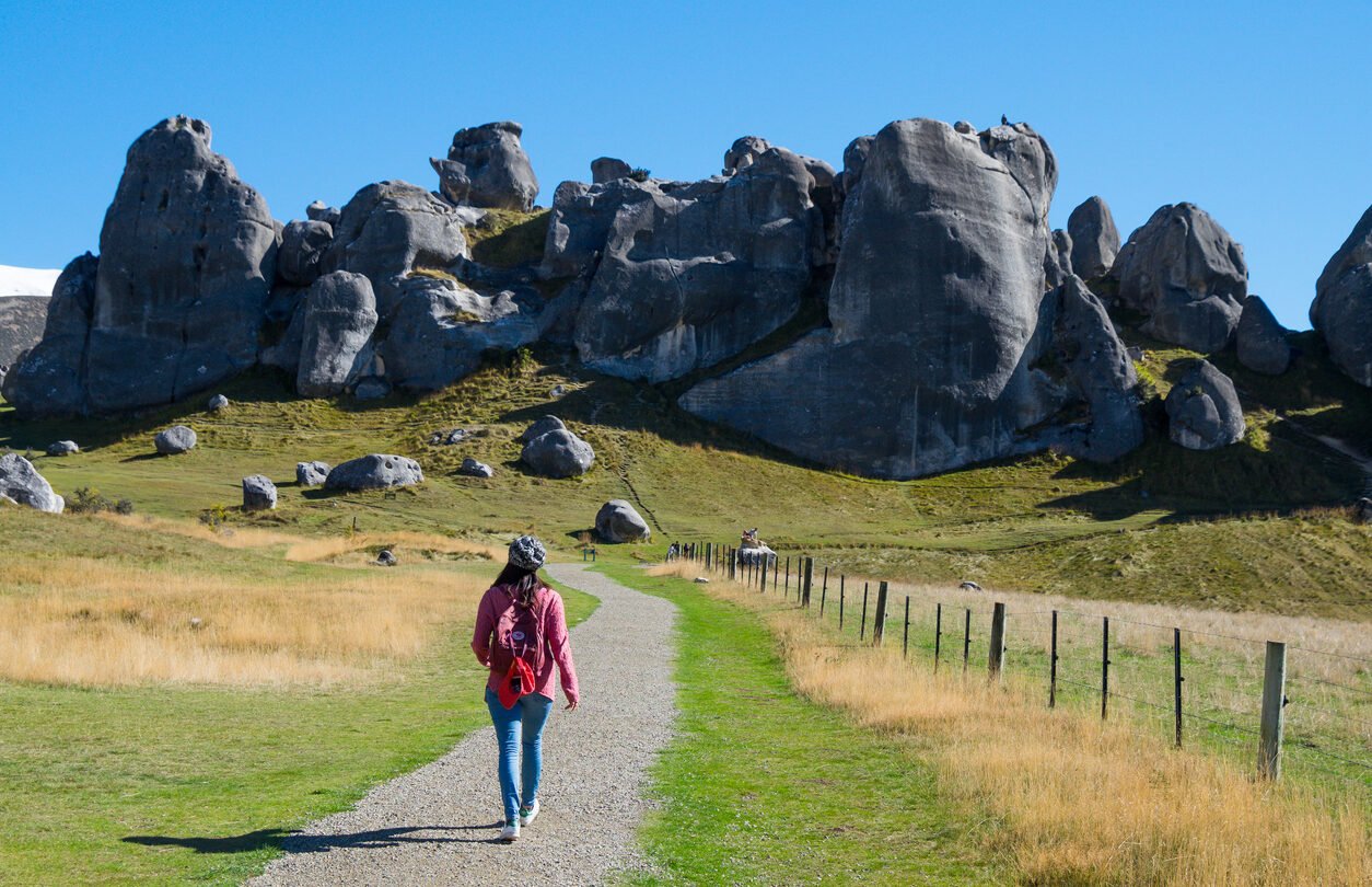 A hiker on a trail to Castle Hill, South Island, New Zealand