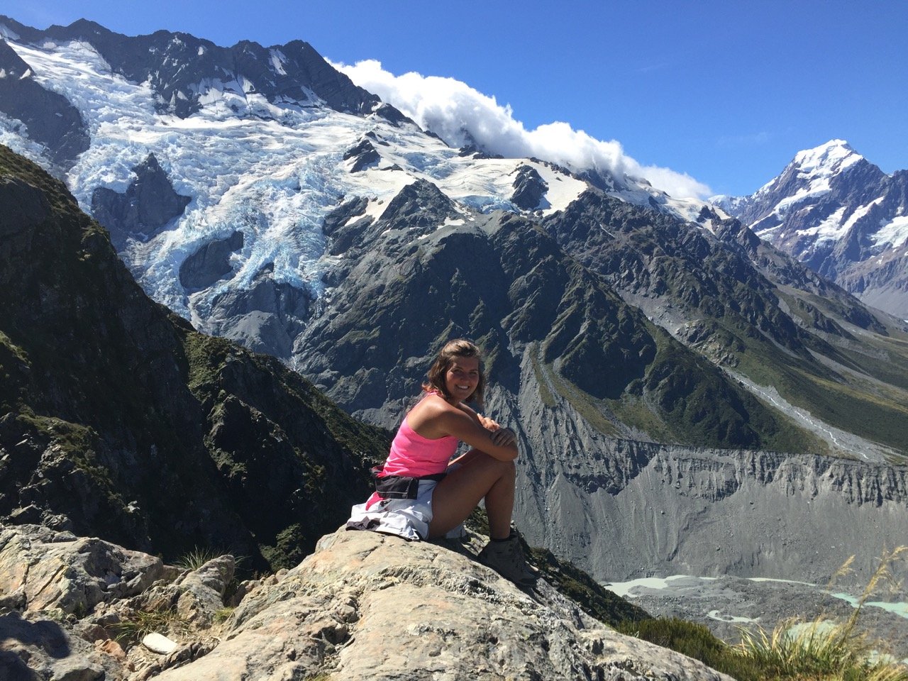 Person sitting on a rock overlooking Sealy Tarns