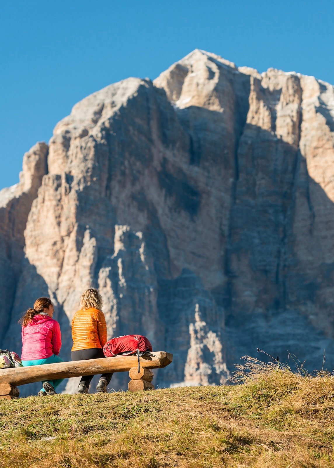 Hikers on a bench in the Dolomites