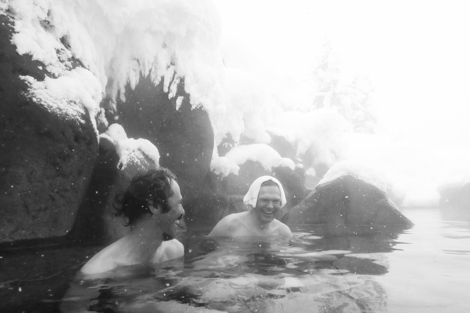 Skiers relaxing in an onsen after a ski trip.