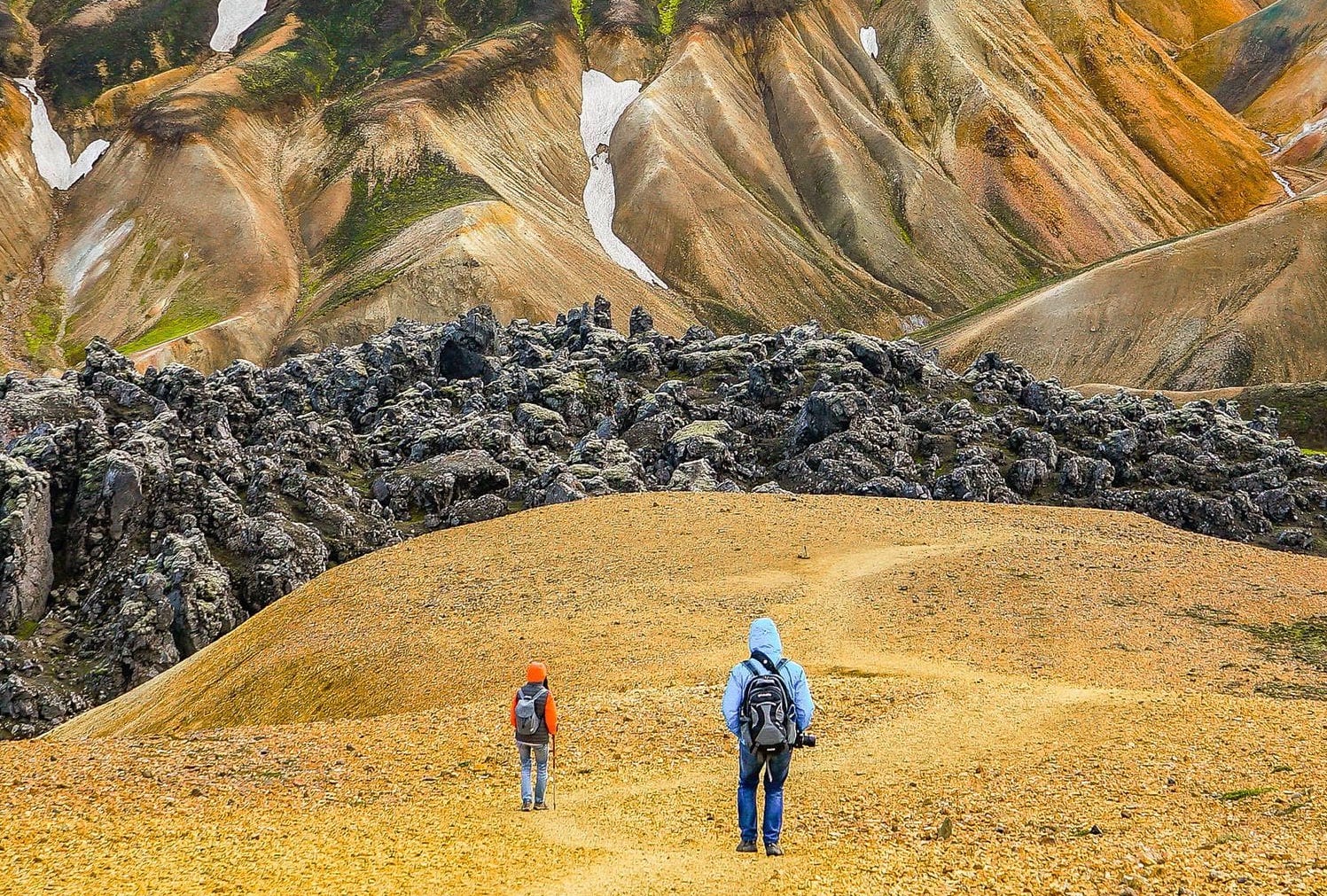 vibrant Reykjafjöll mountains and the Jökultungur area whose colors contrast dramatically with the soft pale sand-toned peaks around them