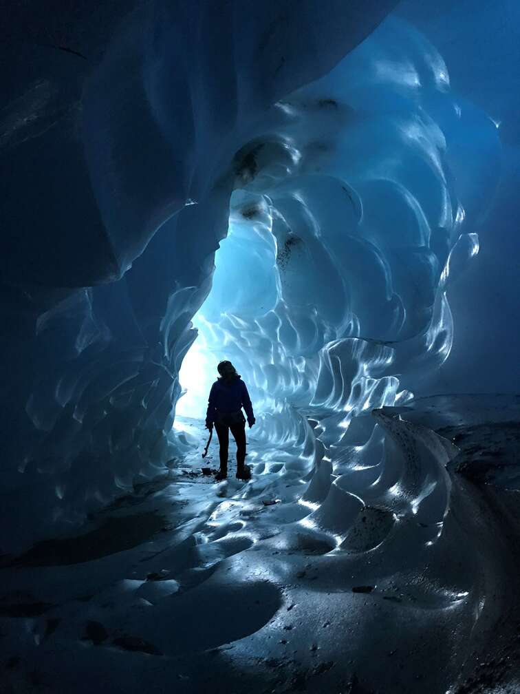 Exploring a deep blue ice cave on Fox Glacier