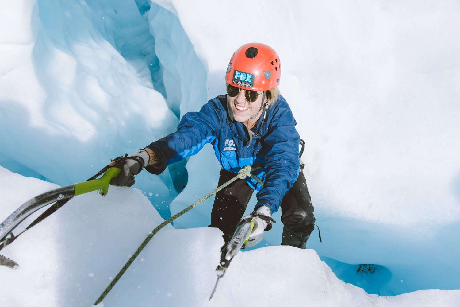 An adventurer ice climbing on Fox Glacier, New Zealand