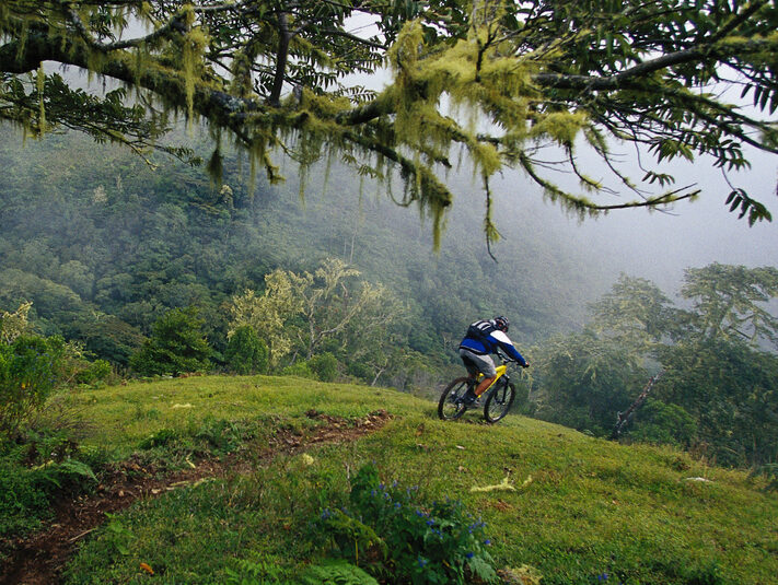 A man rides a downhill mountain bike trail in Costa Rica.