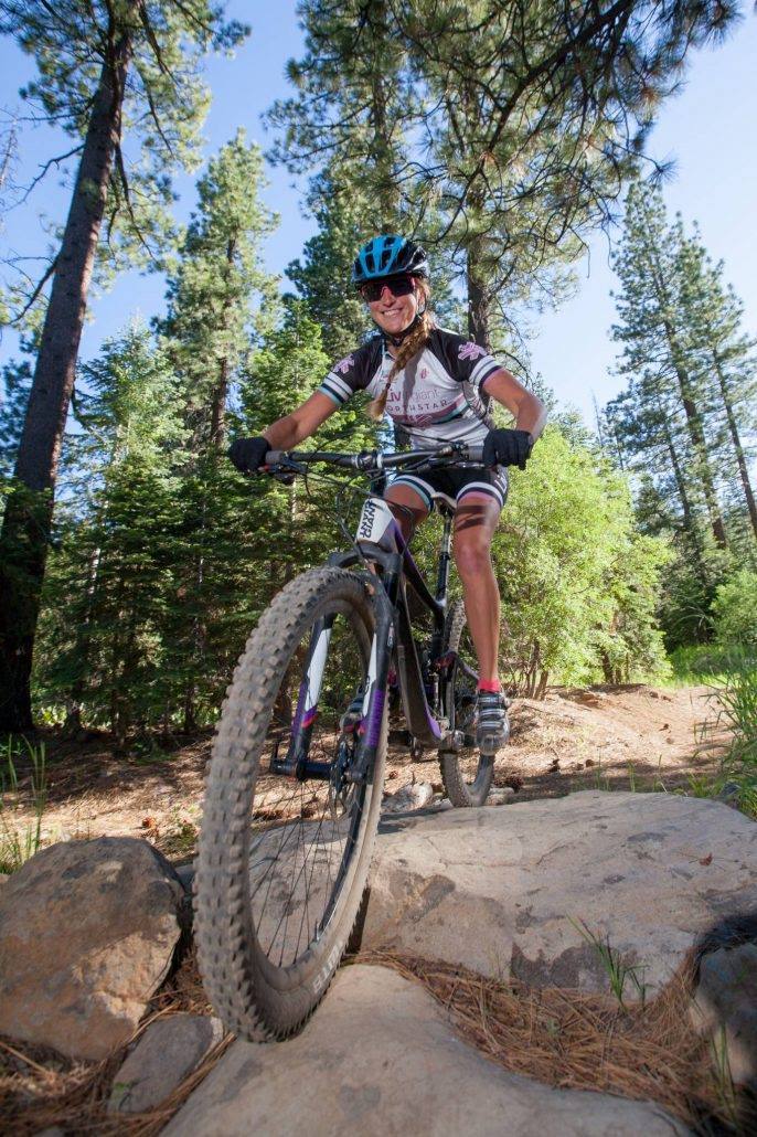 A female biker on a rock in Summit County