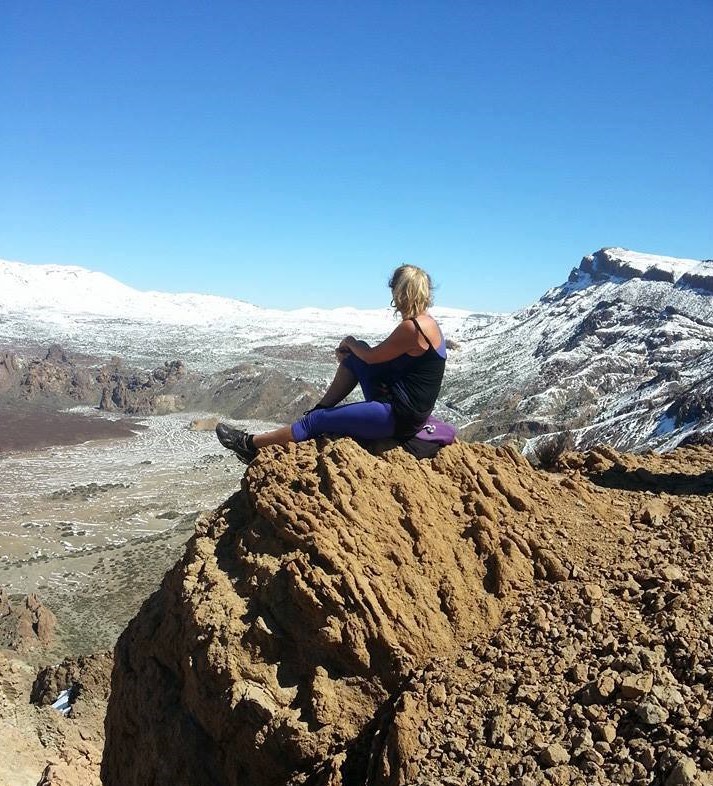 A hiker posing in front of a volcanic landscape on Caldera Rim, Tenerife