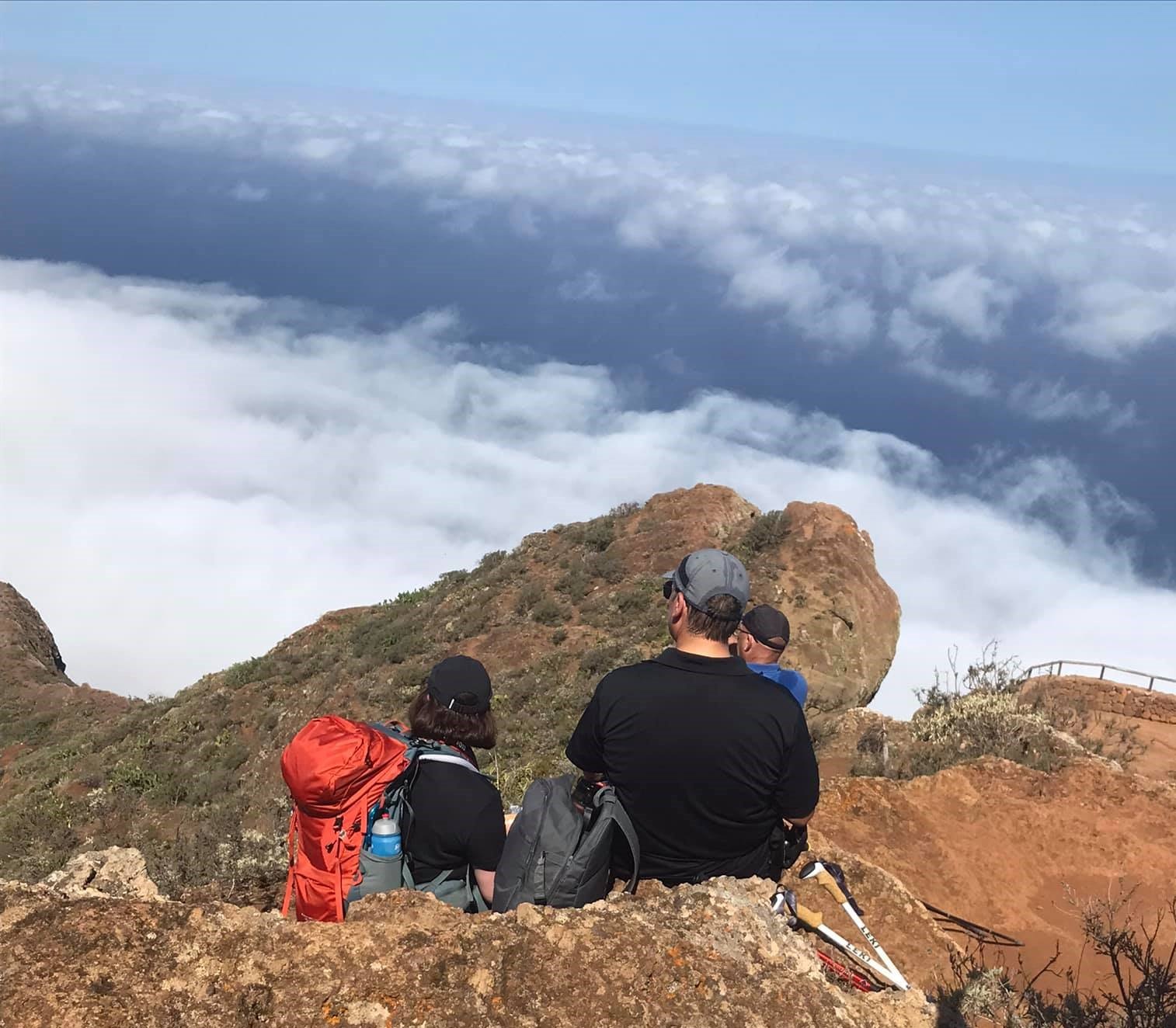 Hikers resting above the clouds in Tenerife