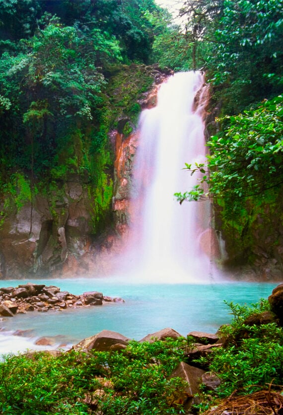 A secluded waterfall in a tropical rainforest. This is the Celeste Waterfalls in Costa Rica (Catarata Celeste).