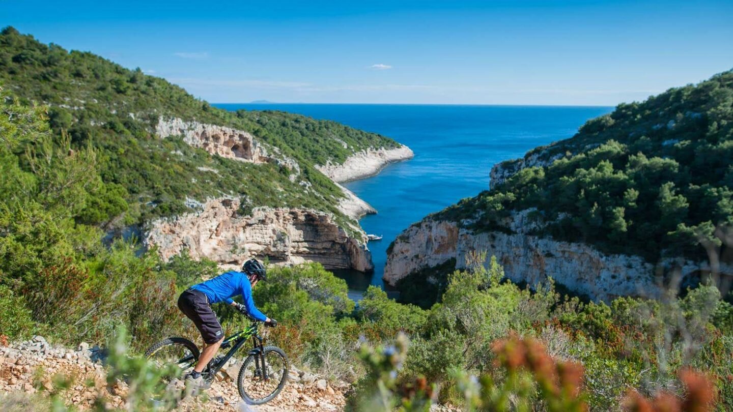 A mountain biker meanders through the island of Vis.