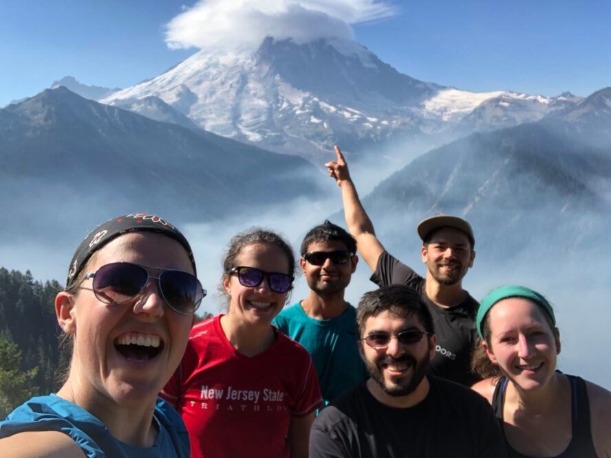 Group of hikers enjoying the view of Mount Rainier under a lenticular cloud.