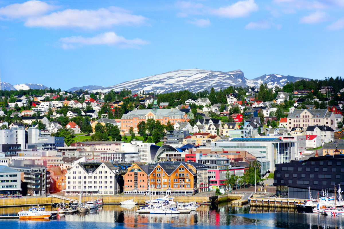 View of the Tromso harbor with mountains and sky in the background. 