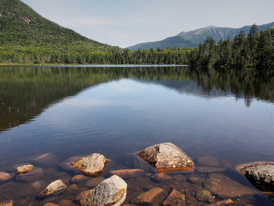 Lonesome Lake with the mountains of Franconia Range off in the distance. 