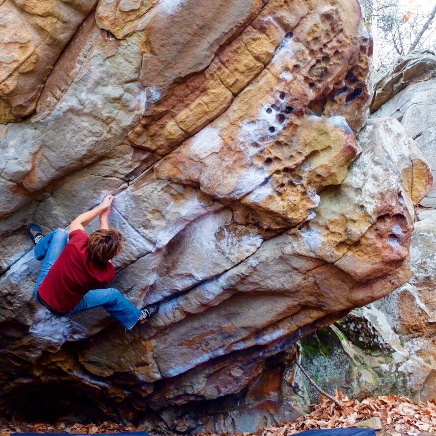 Philip Ferrara climbs the classic problem Super Mario (V4) at Stone Fort. 