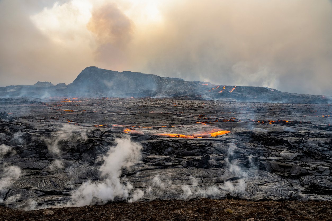 View of landscapes close to the erupting volcano with lava firming up.