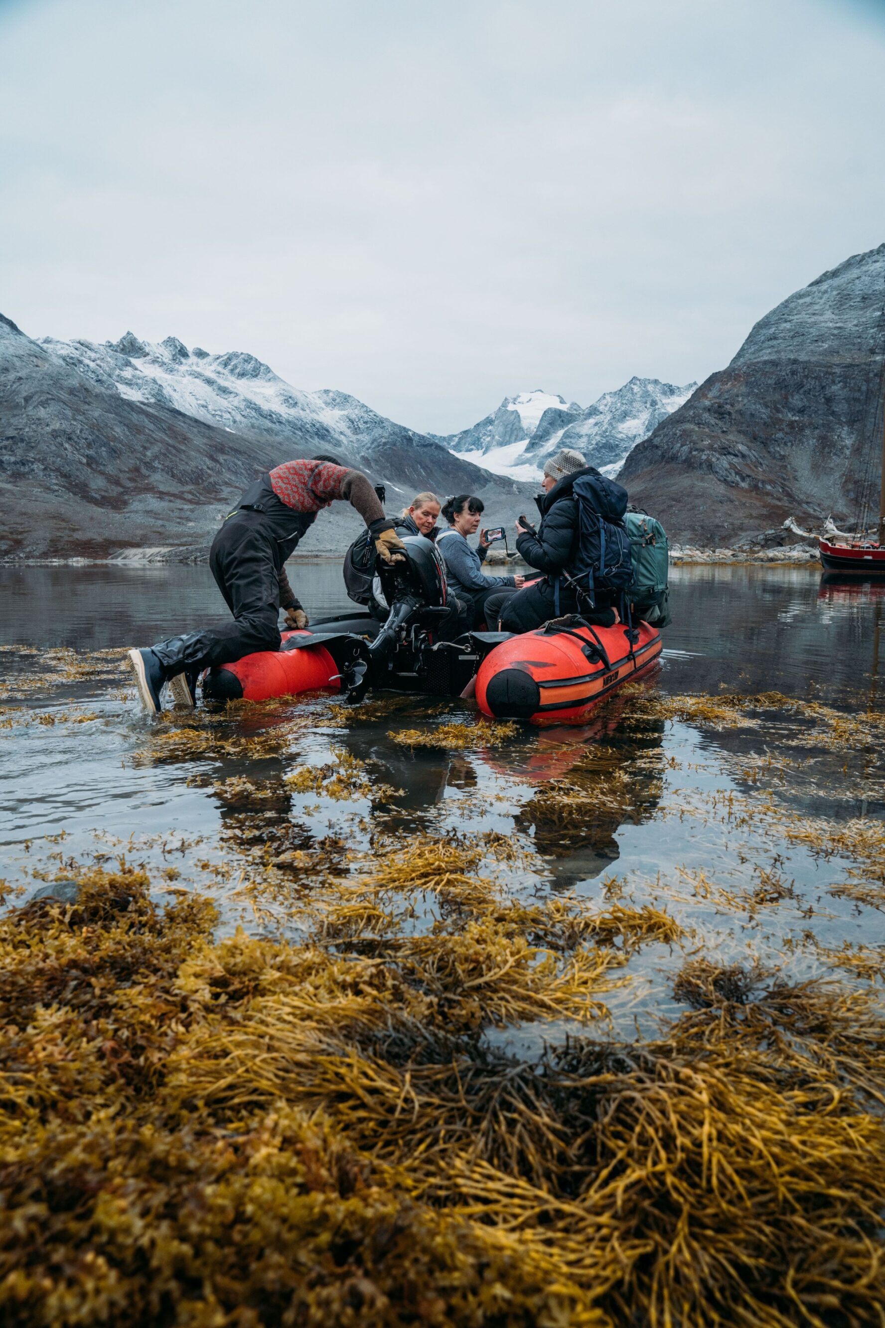 Hikers on a dinghy in Greenland