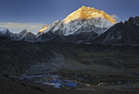 Sun has set over the village at the foot of Everest, only illuminating the peak in the distance