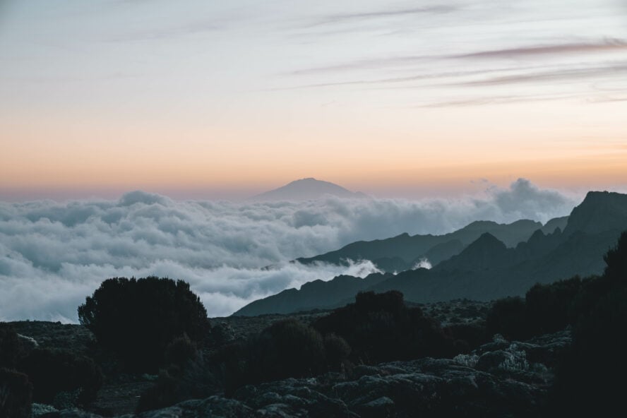 Mount Meru poking above the clouds as seen from Barranco Camp.