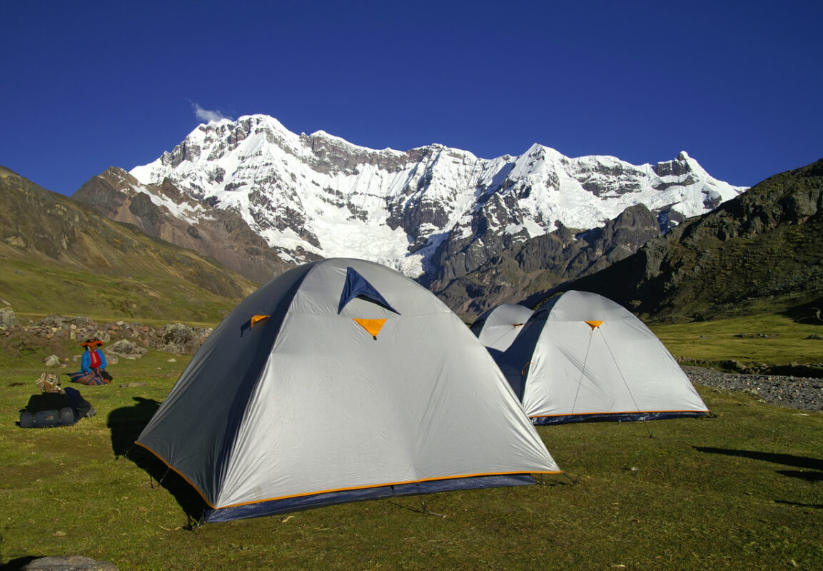 Tents in the Ausangete Base Camp, the area is dominated by a lofty Andean peak.