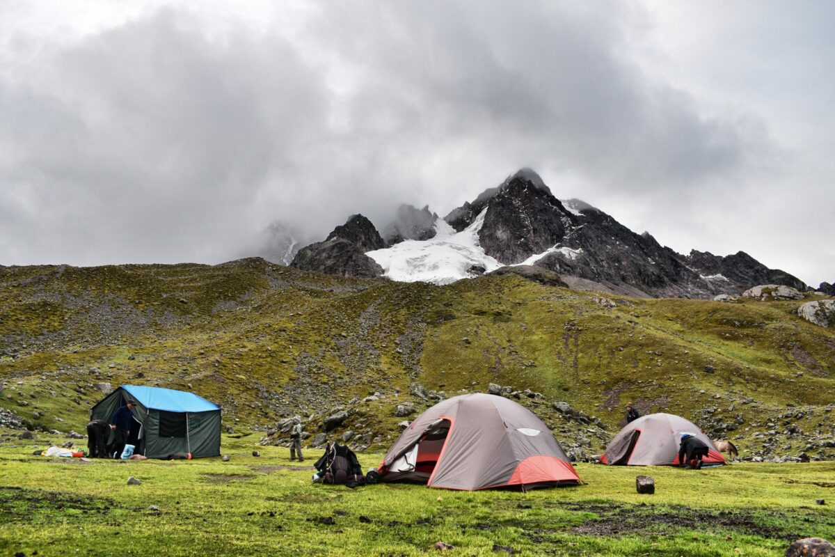 Tents set up at Pacchanta, a campsite along the Ausangate Trek with views of fog-covered glaciated peaks.