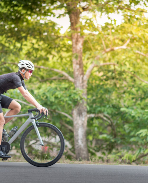 Young man Cyclist riding mountain bike in public park at moring