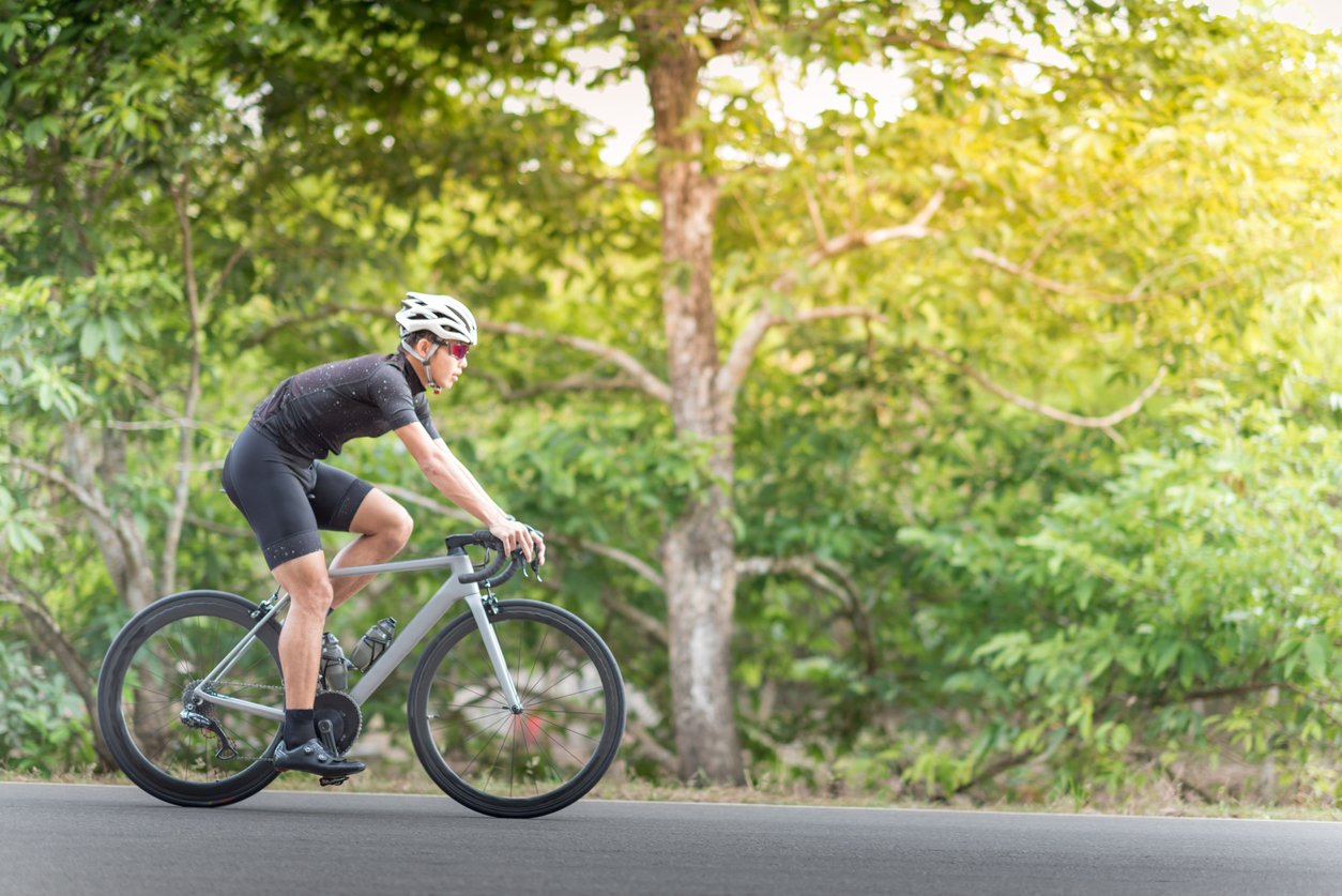 Young man Cyclist riding mountain bike in public park at moring