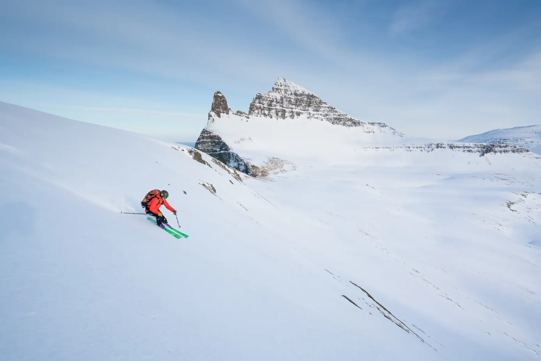 A skier on a fresh track in the Westfjords, Iceland.