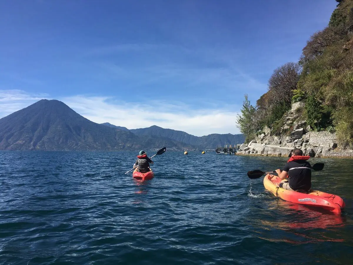 Adventurers kayaking along the north shore of Lake Atitlan.
