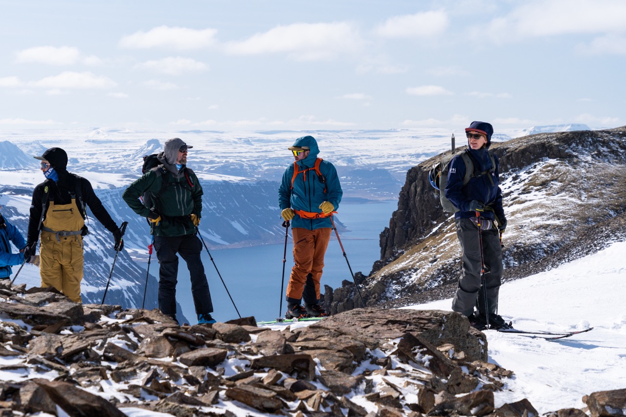 Skiers making plans for skiing after reaching the summit