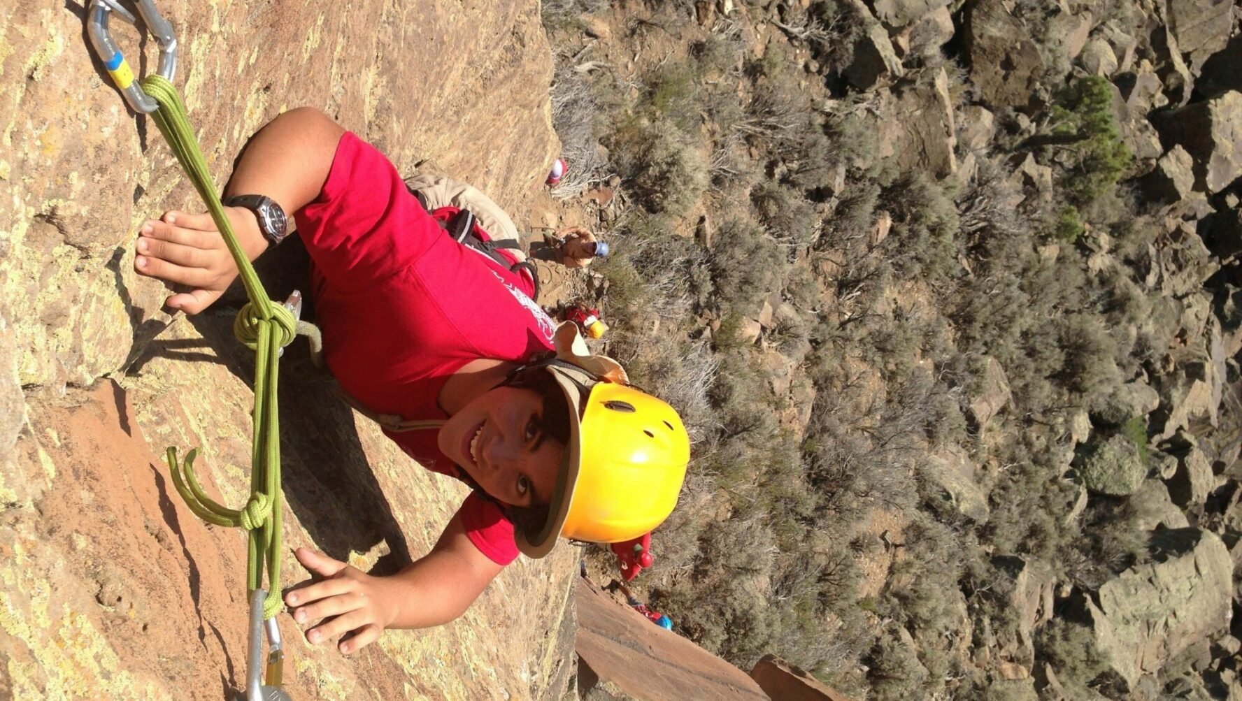 Rock climber looking up from the crag.